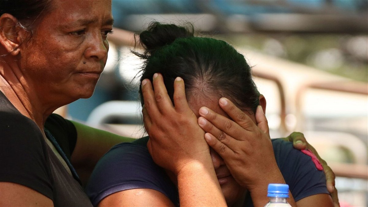 <i>Cesar Munoz/AP</i><br/>Relatives of prisoners at a penitentiary in Ecuador learn about the fatal clashes in Guayaquil on Tuesday