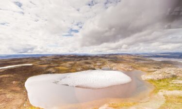 Melting ice on a small tundra pond in Greenland.