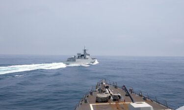 The Chinese warship Luyang III sails near the American destroyer USS Chung-Hoon