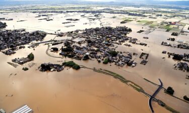 Ohashi Elementary School and the surrounding area are inundated after the Kosegawa River flooded following torrential rain on July 10