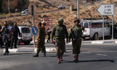 Israeli military and security personnel work at the scene of a shooting attack at Tekoa Junction in the Israeli-occupied West Bank on July 16.