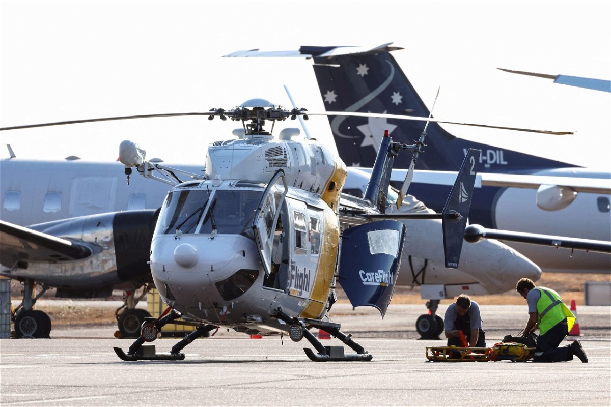 A Care Flight helicopter is seen on the tarmac of the Darwin International Airport in Darwin on August 27. Three US Marines died on August 27 after an Osprey aircraft crashed on a remote tropical island north of Australia during war games, US military officials said.