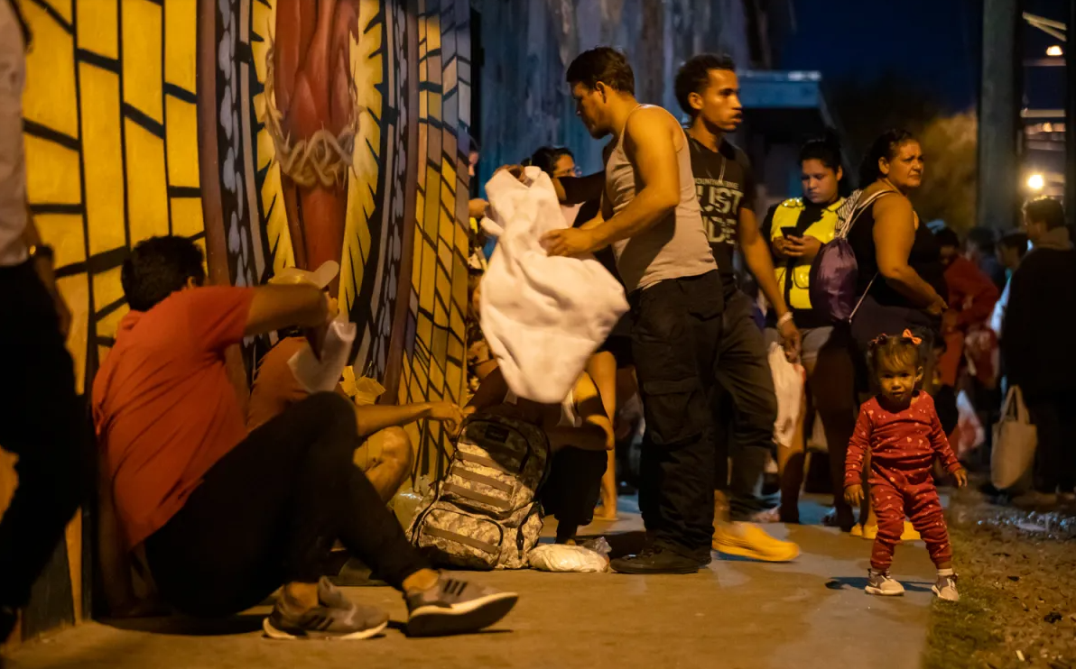 Dozens of migrants are outside Sacred Heart Church on the night of Wednesday, Sept. 13, as shelters in both Juárez and El Paso are at capacity.