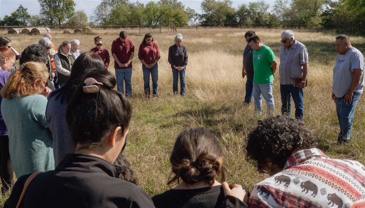 Attendees gather in a circle during a blessing ceremony for the bison gifted to Theda Pogue, affiliated with the Muscogee (Creek) Nation of Oklahoma, and her family on Nov. 4, 2023 at GP Ranch in Sulphur Springs, Texas.