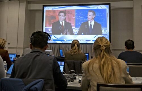 Florida Gov. Ron DeSantis and California Gov. Gavin Newsom appear on screen from the press room during a debate held by Fox News