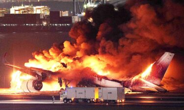 The burn-out Japanese coast guard aircraft is seen at Haneda airport on January 3