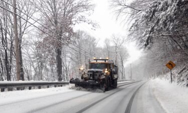 A snow plow operates during a storm in Hudson