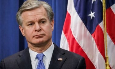 FBI Director Christopher Wray looks on during a press conference at the U.S. Department of Justice on December 6