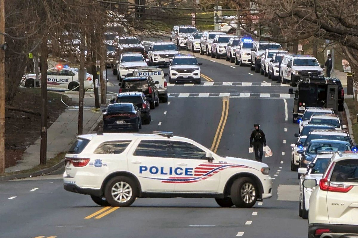 Police are shown near the scene where three police officers were shot Wednesday in Washington