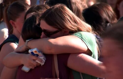 People hug at a vigil for Laken Hope Riley at the University of Georgia in Athens