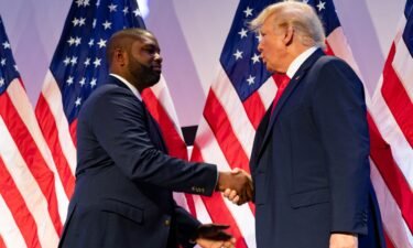 Congressman Byron Donalds shakes hands with of Former President and Republican presidential candidate Donald Trump at the Moms for Liberty Summit in Philadelphia