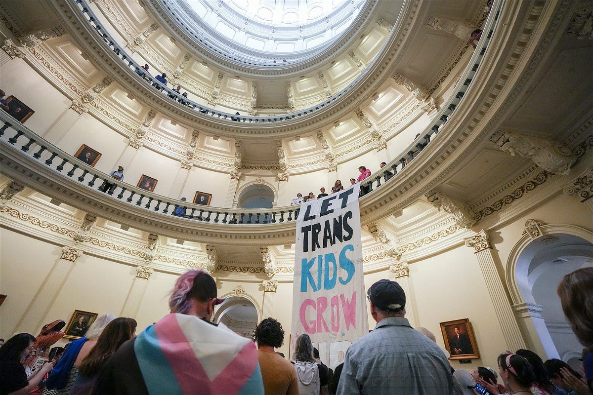 Equality Texas leadership drops a banner in the Capitol rotunda as LGBTQ rights activists protest SB14 at the Capitol of Texas in May 2023. The state of Texas is suing the Biden administration over recently announced federal protections for LGBTQ+ students.