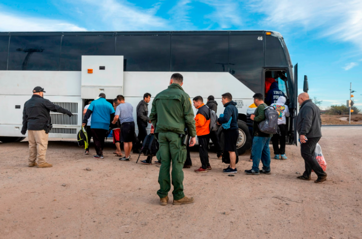 Immigrants file into a U.S. Customs and Border Protection bus after crossing the U.S.-Mexico border January 07, 2024 in Eagle Pass, Texas.