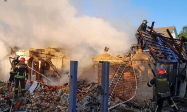 Rescuers assess the ruins of a building