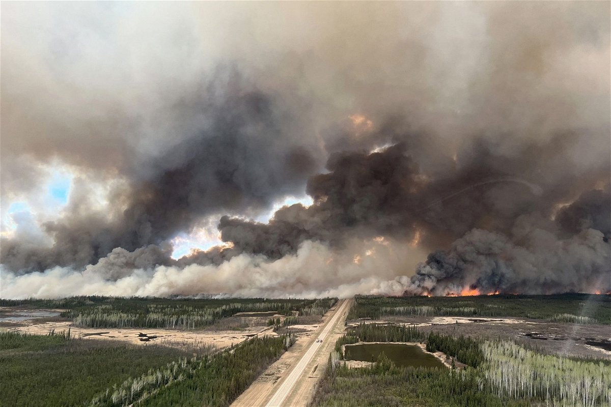 The Parker Lake Fire glows in an aerial photograph taken by a British Columbia Emergency Health Services crew member through the window of an airplane evacuating patients from nearby Fort Nelson