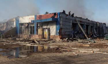 Rescuers work at the site of Russian airstrikes in the village of Lyptsi