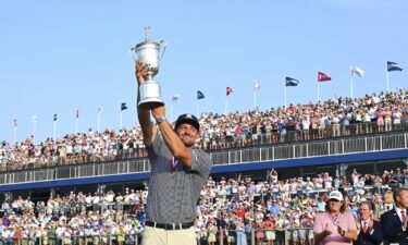 Bryson DeChambeau lifts aloft the US Open trophy after winning the major.