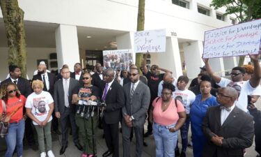 DeAsia Harmon is seen to the left of attorney Ben Crump