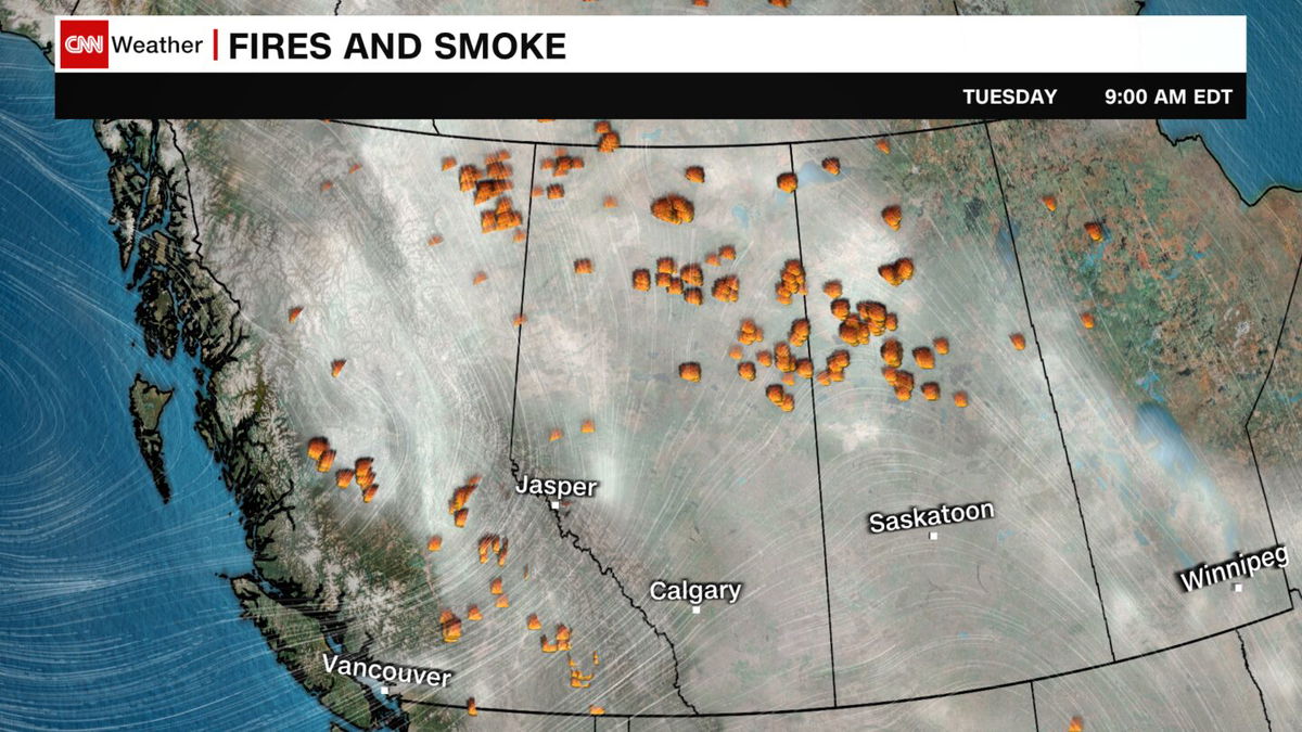 <i>Carolyn Campbell/The Canadian Press/AP via CNN Newsource</i><br/>Cars clog the highway as people evacuate because of wildfires early July 23