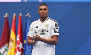 Kylian Mbappe poses with his parents inside the Santiago Bernabéu.