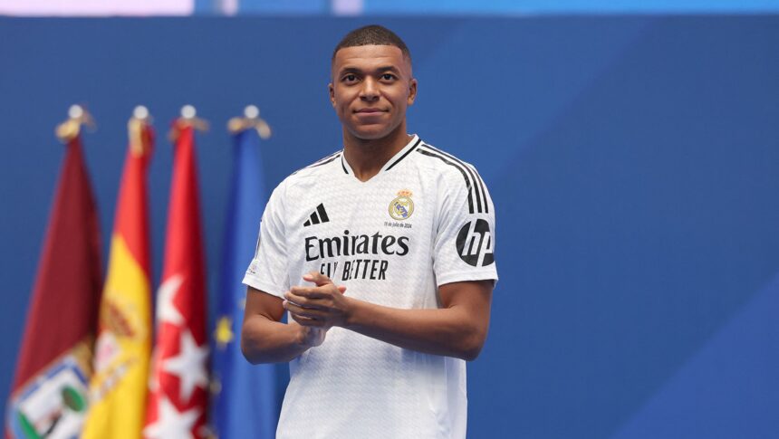 <i>Juan Medina/Reuters via CNN Newsource</i><br/>Kylian Mbappe poses with his parents inside the Santiago Bernabéu.