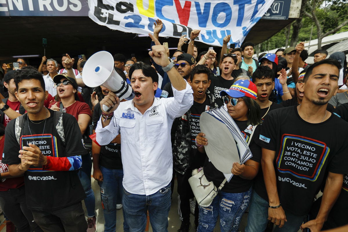 <i>Juan Barreto/AFP/Getty Images via CNN Newsource</i><br/>Supporters of Venezuelan President Nicolas Maduro hand out flyers in the neighborhood of Agua de Maiz in Caracas on July 11