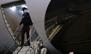 President Joe Biden gestures to reporters as he steps off Air Force One upon arrival at Dover Air Force Base on July 17.