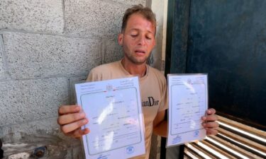 Mohammad Abu Al Qumsan holding the birth certificates for his twins