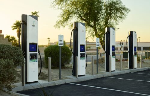 A line of EVs wait to charge at Electrify America chargers in East Brunswick