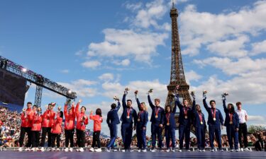 Members of the U.S. Olympic figure skating team celebrate with their gold medals from Beijing 2022.