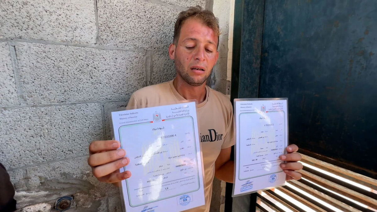 <i>CNN via CNN Newsource</i><br/>Mohammad Abu Al Qumsan holding the birth certificates for his twins