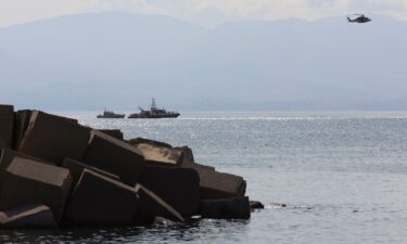 Emergency crews search the coast off the Italian port of Porticello