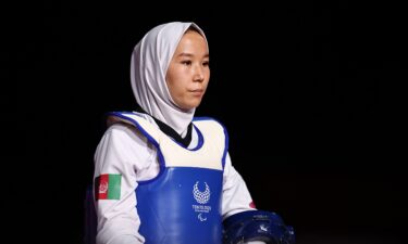 Hossain Rasouli (left) and Zakia Khudadadi carry Afghanistan's flag at the closing ceremony of the Tokyo Paralympics.