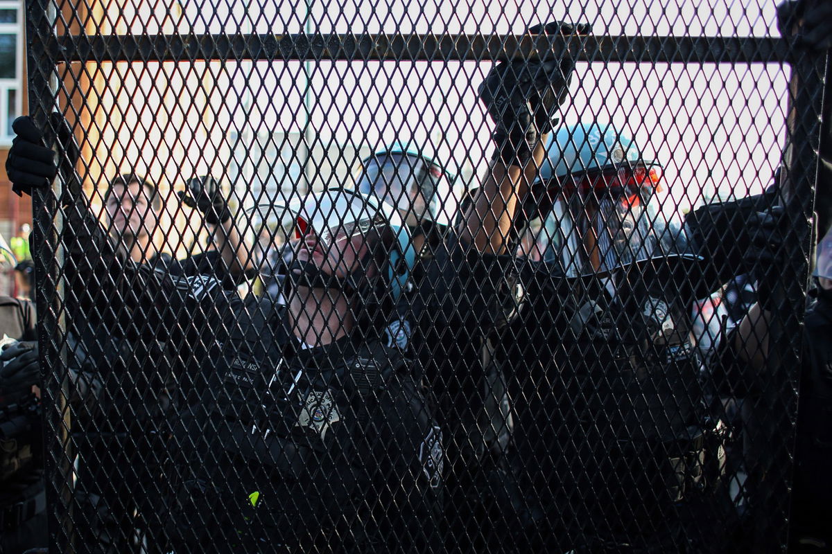 <i>Jim Vondruska/Getty Images via CNN Newsource</i><br/>Chicago police secure fencing after a breach in the security barrier ahead of the Democratic National Convention on August 19