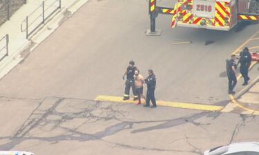 The gunman is led away from the King Soopers store by first responders.