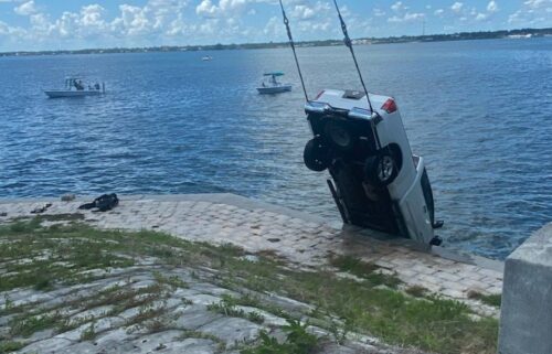 Bystanders helped rescue the driver of a truck that crashed into a body of water over the weekend