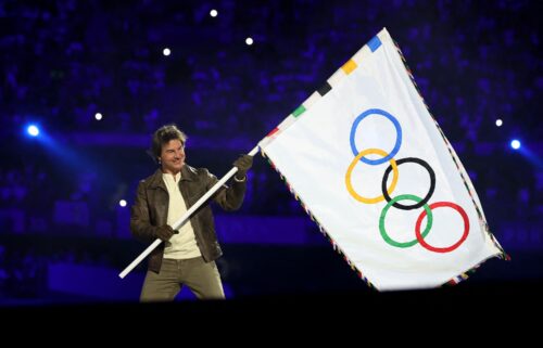 Tom Cruise holds the Olympic flag during the Closing Ceremony of the Olympic Games Paris 2024 at Stade de France on August 11.