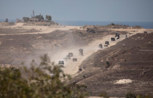 An Israeli army convoy moves along the border with the Gaza Strip in southern Israel on August 21