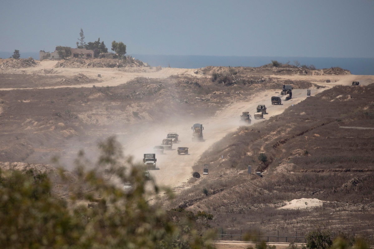 <i>Amir Levy/Getty Images/File via CNN Newsource</i><br/>An Israeli army convoy moves along the border with the Gaza Strip in southern Israel on August 21