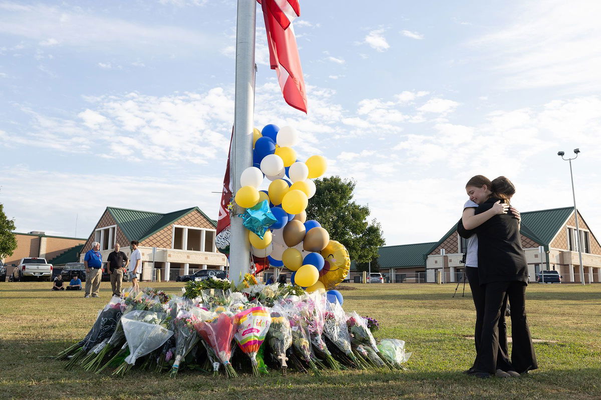 <i>Jessica McGowan/Getty Images via CNN Newsource</i><br/>Students embrace near a makeshift memorial at Apalachee High School on September 5 in Winder