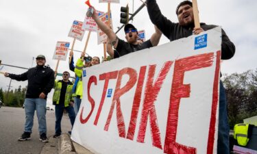 Workers with picket signs outside the Boeing Co. manufacturing facility during a strike in Everett