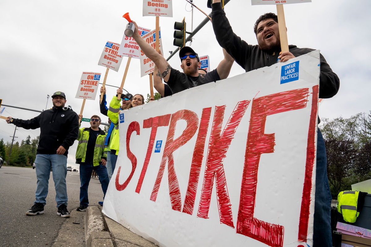 <i>M. Scott Brauer/Bloomberg/Getty Images via CNN Newsource</i><br/>Workers with picket signs outside the Boeing Co. manufacturing facility during a strike in Everett