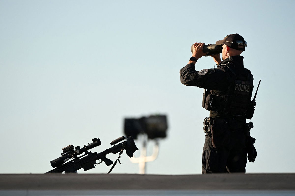 <i>Roberto Schmidt/AFP/Getty Images via CNN Newsource</i><br/>A Secret Service sniper team member stands guard as he waits for Donald Trump to arrive at Philadelphia International Airport in Philadelphia