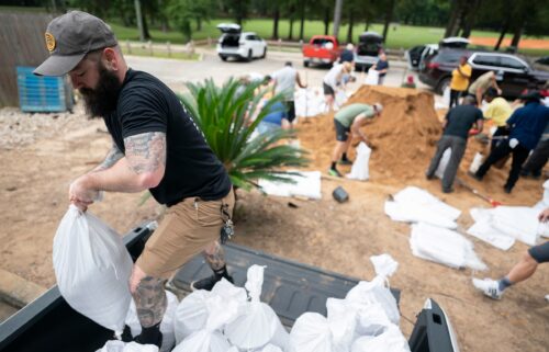 People bag sand in preparation for possible flooding as Tropical Storm Helene heads toward the state's Gulf Coast on September 25 in Tallahassee