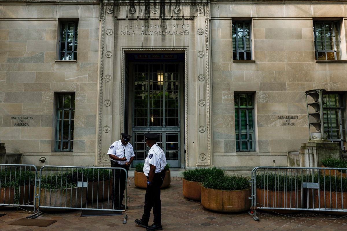 <i>Anna Moneymaker/Getty Images via CNN Newsource</i><br/>Police officers stand in front of the Department of Justice in Washington