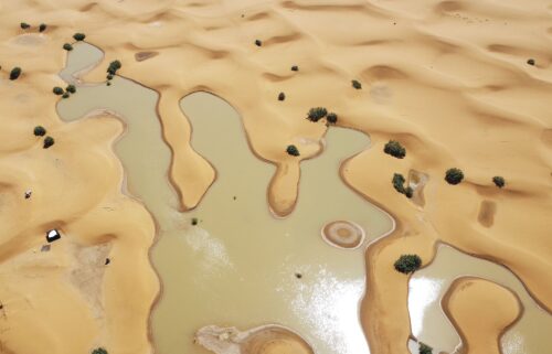 Buildings along a lake filled by heavy rainfall are pictured in the desert town of Merzouga on October 2.