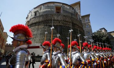 Members of the Vatican's elite Swiss Guard march in front of the Institute for the Works of Religion (IOR).