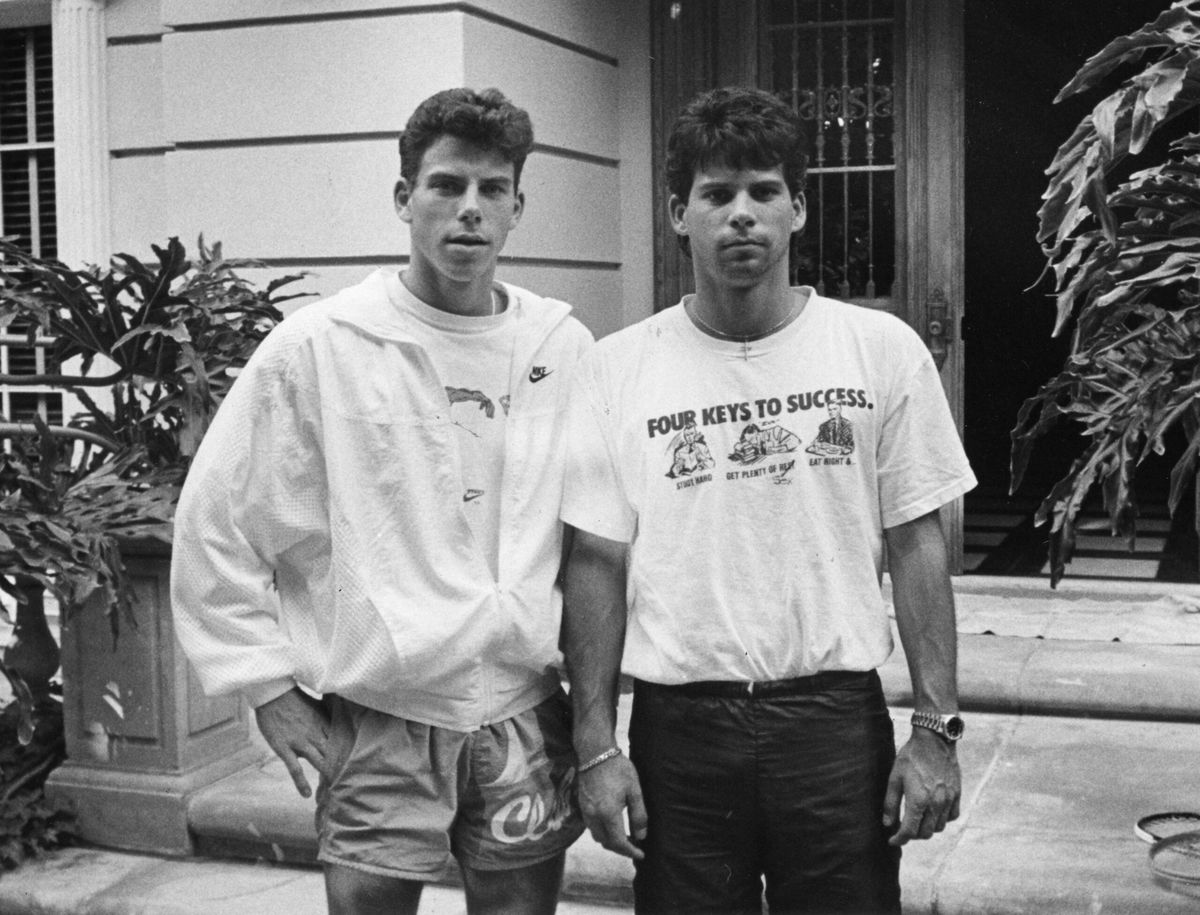 In this undated file photo, Erik Menendez, left, and is brother Lyle, stand in front of their former Beverly Hills home. On Thursday, prosecutors in Los Angeles announced they are reviewing new evidence presented in their case ahead of a hearing next month.