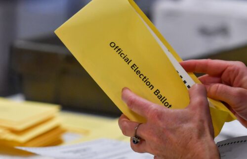 Wake County Board of Elections member Keith Weatherly signs a box of mail-in ballots at the Wake County Board of Elections ballot processing center in Raleigh