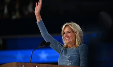 First lady Jill Biden waves from the stage on the opening night of the DNC on Monday